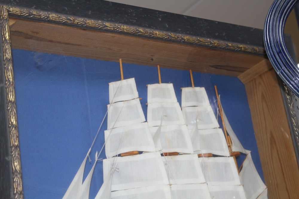 A painted wood ship model, in display frame, overall 42 x 52cm